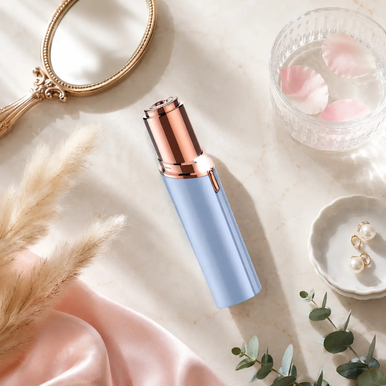 Blushvelle Glow Razor Pro on a marble vanity with eucalyptus, pearls and rose petals